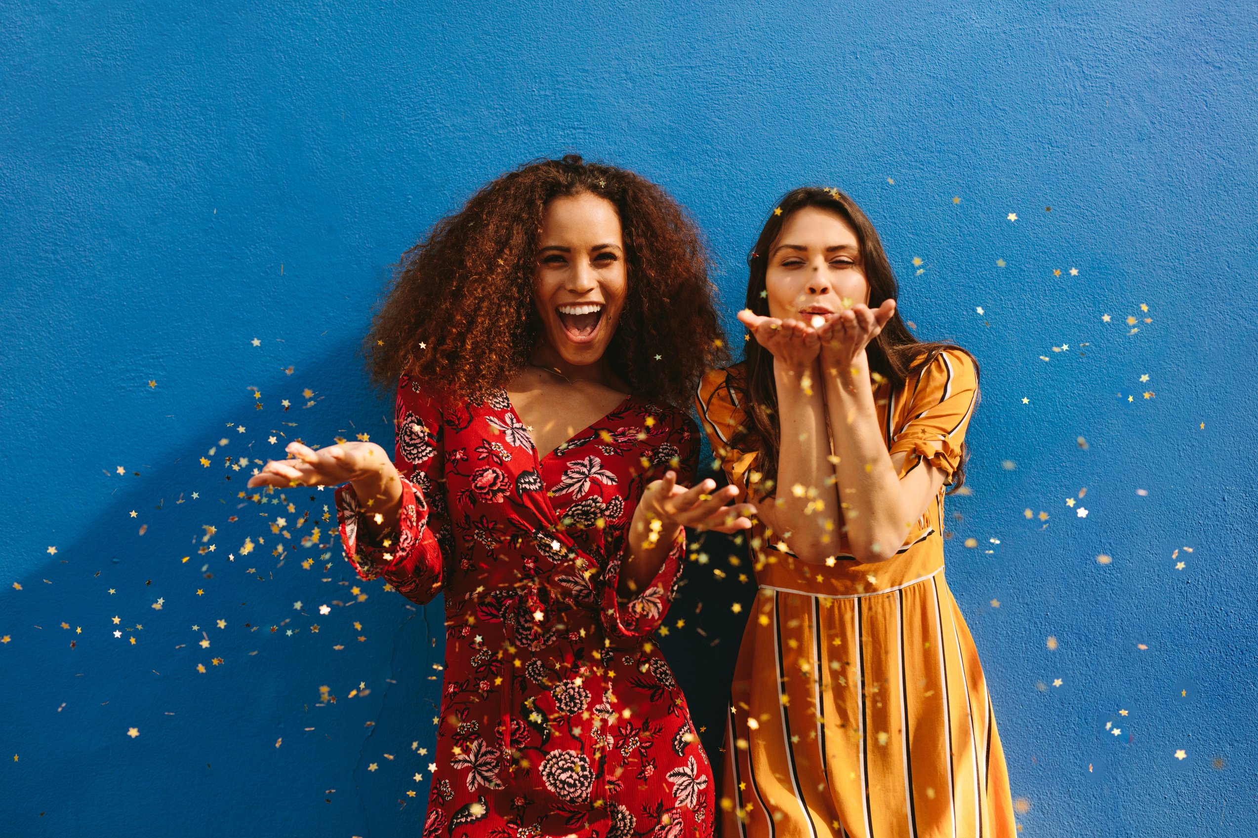 Female Friends Blowing off Magic Glitter